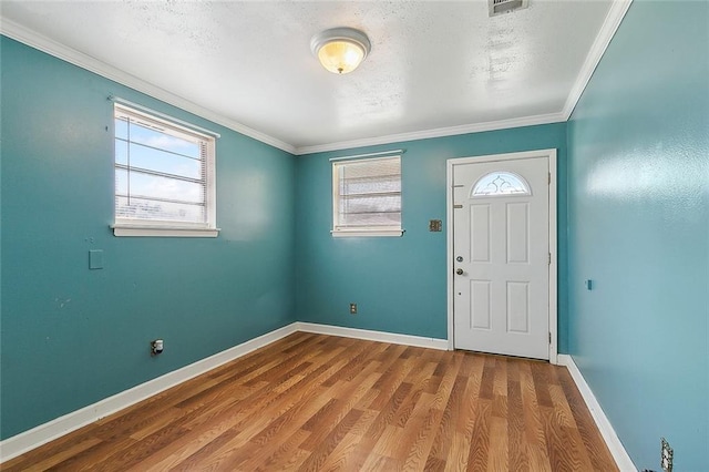 foyer entrance featuring wood-type flooring and crown molding