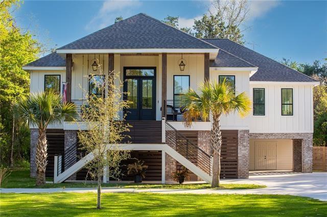 view of front of home with a front yard, french doors, and a garage