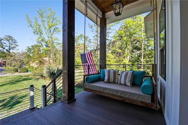 deck with covered porch and a lawn