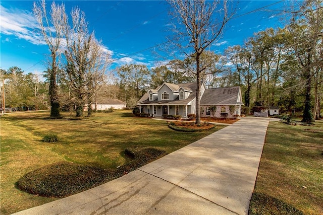 new england style home featuring a front lawn