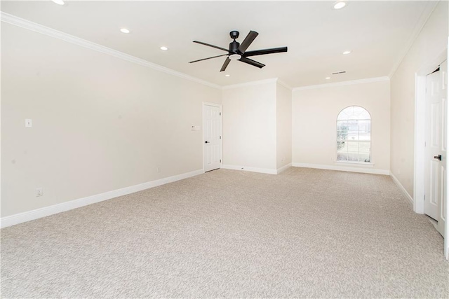 spare room featuring light carpet, ceiling fan, and ornamental molding