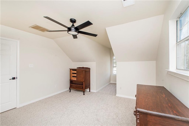 additional living space with light carpet, ceiling fan, lofted ceiling, and plenty of natural light