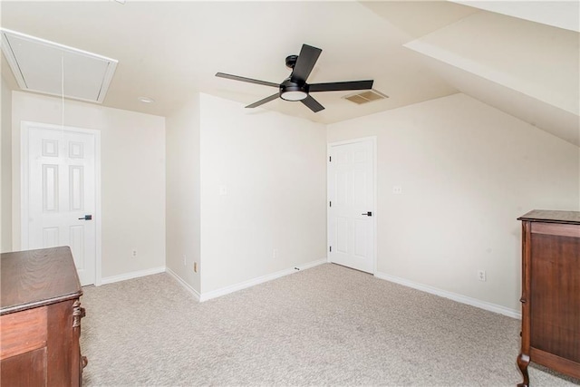 unfurnished bedroom featuring ceiling fan, light carpet, and vaulted ceiling