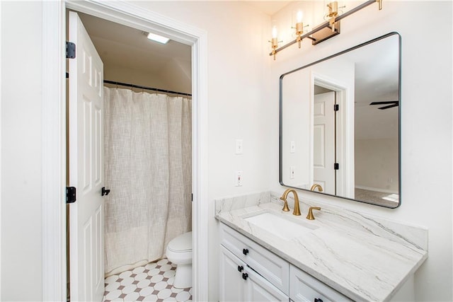 bathroom featuring ceiling fan, toilet, vanity, and a shower with curtain