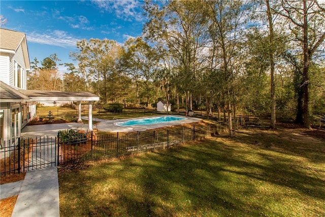 view of pool with a lawn and a patio