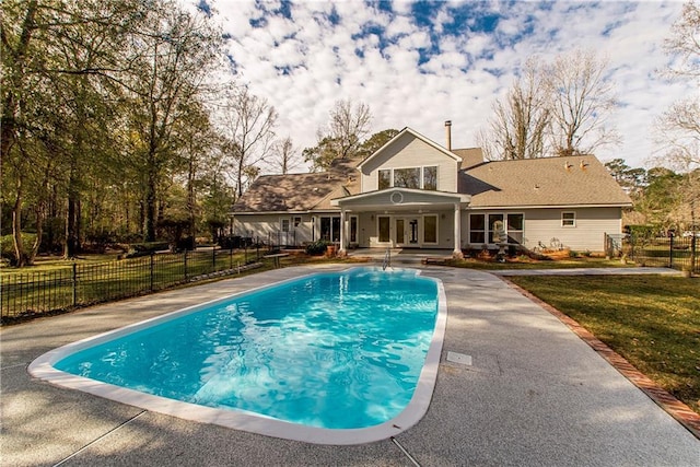 view of swimming pool with a yard, french doors, and a patio