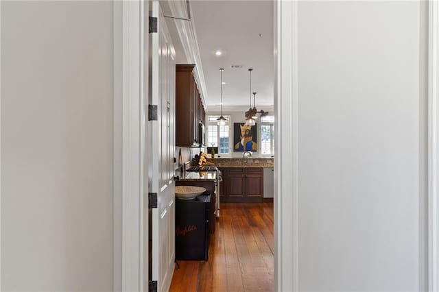 hallway with dark hardwood / wood-style flooring and sink