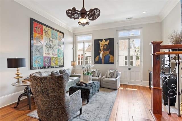 living area featuring crown molding and hardwood / wood-style floors