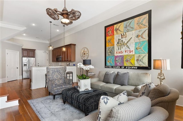 living room with ornamental molding and dark hardwood / wood-style flooring