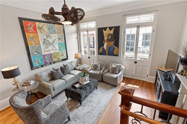 living room with crown molding and wood-type flooring