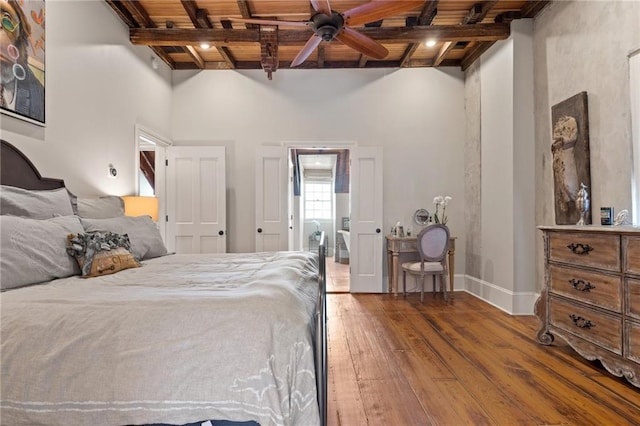 bedroom featuring beam ceiling, hardwood / wood-style floors, and wood ceiling