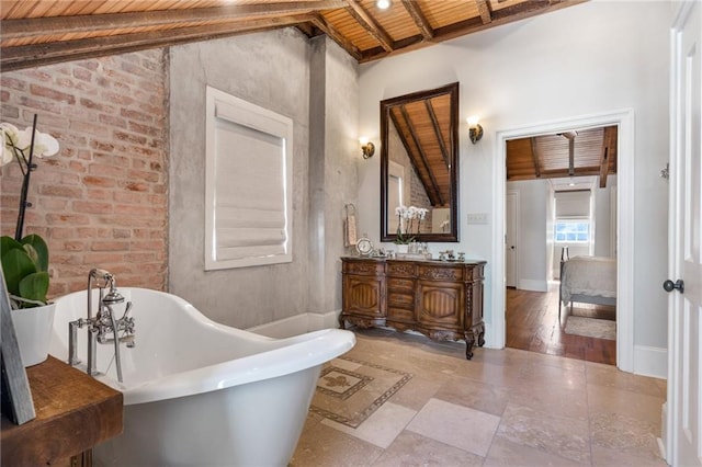 bathroom featuring vanity, a bathing tub, lofted ceiling with beams, and wooden ceiling