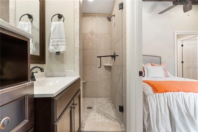 bathroom with walk in shower, ceiling fan, and vanity