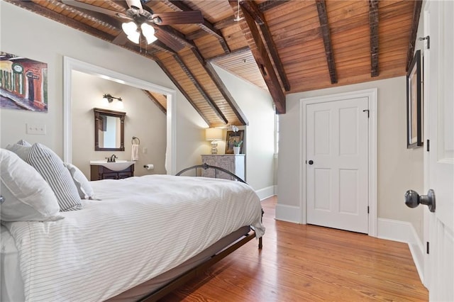 bedroom with sink, lofted ceiling with beams, wooden ceiling, and light wood-type flooring