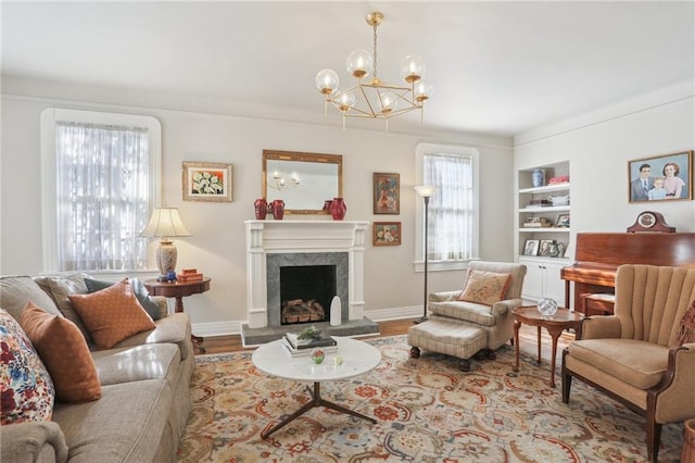 living room featuring an inviting chandelier, built in features, and hardwood / wood-style flooring