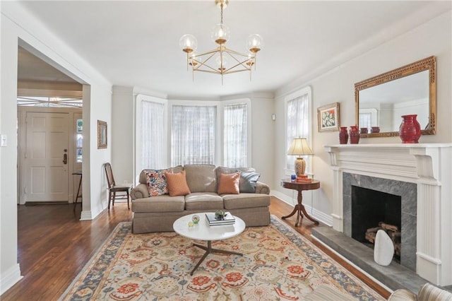 living room featuring a fireplace, an inviting chandelier, and dark hardwood / wood-style floors