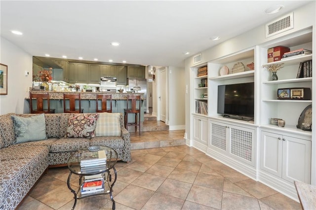 tiled living room featuring built in features