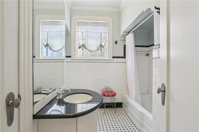 bathroom featuring sink, tile walls, crown molding, and shower / bath combo