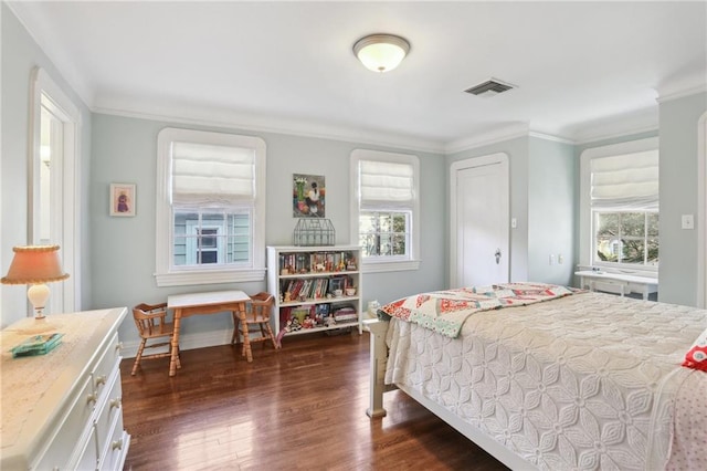 bedroom with crown molding and dark hardwood / wood-style floors