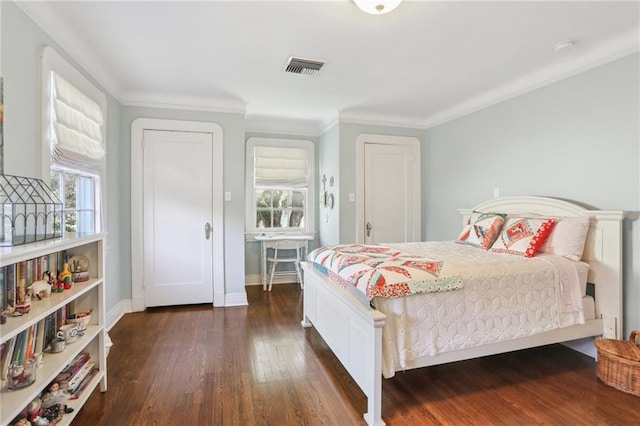 bedroom featuring crown molding and dark hardwood / wood-style floors