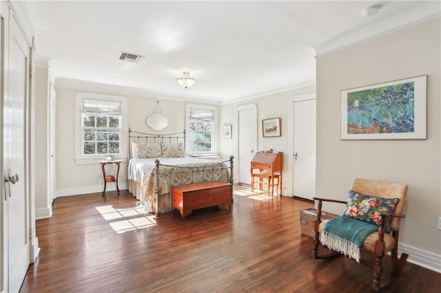 bedroom featuring ornamental molding and dark hardwood / wood-style flooring