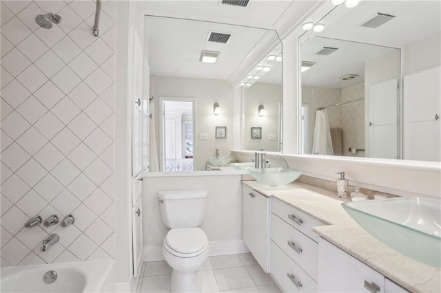 full bathroom featuring toilet, vanity, tile patterned flooring, and shower / bath combination with curtain