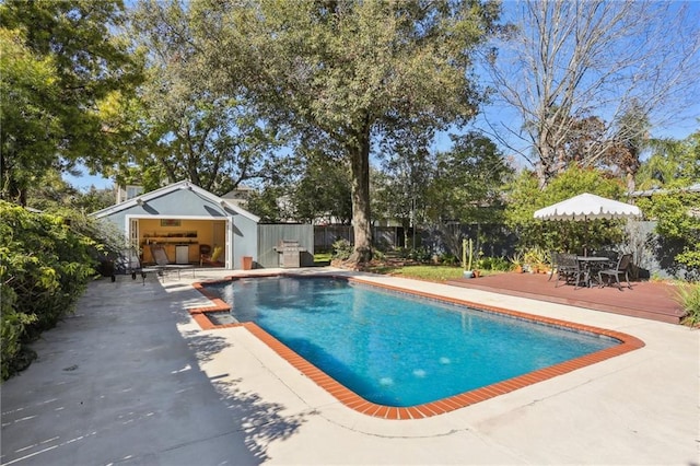 view of pool featuring a patio area and an outbuilding