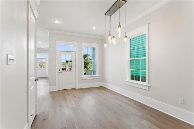 interior space featuring crown molding and light wood-type flooring