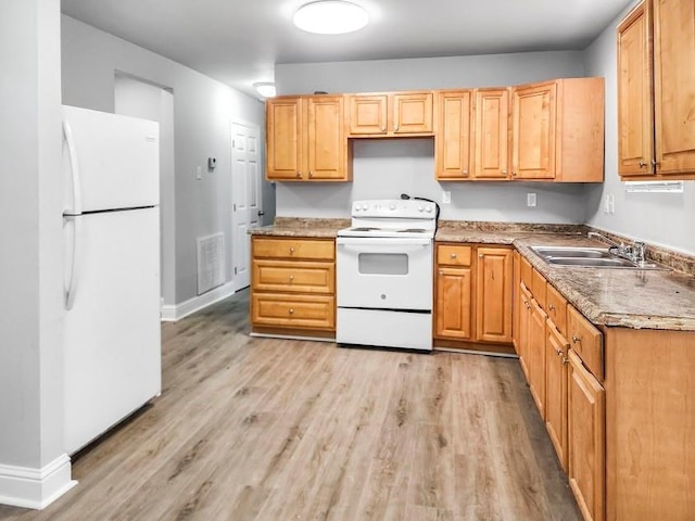 kitchen with light wood-type flooring, sink, and white appliances