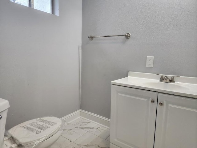 bathroom with toilet and vanity