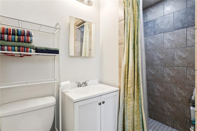 bathroom with toilet, vanity, and a shower with shower curtain