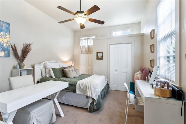 carpeted bedroom featuring ceiling fan and a closet