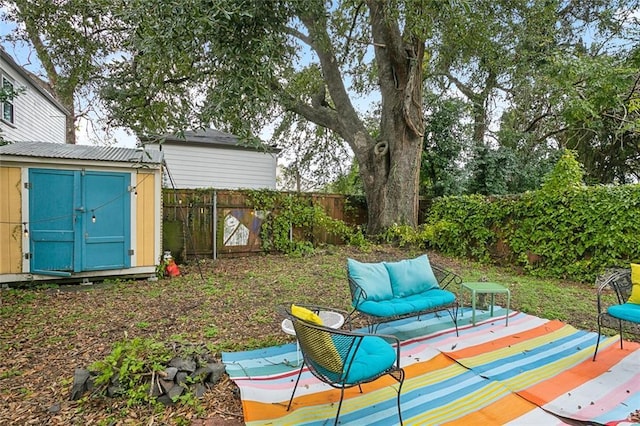 view of yard with an outdoor hangout area and a storage unit