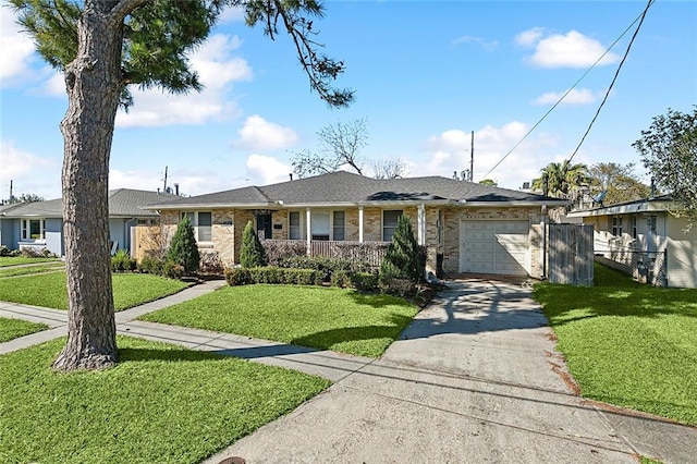 single story home featuring a front yard, covered porch, and a garage