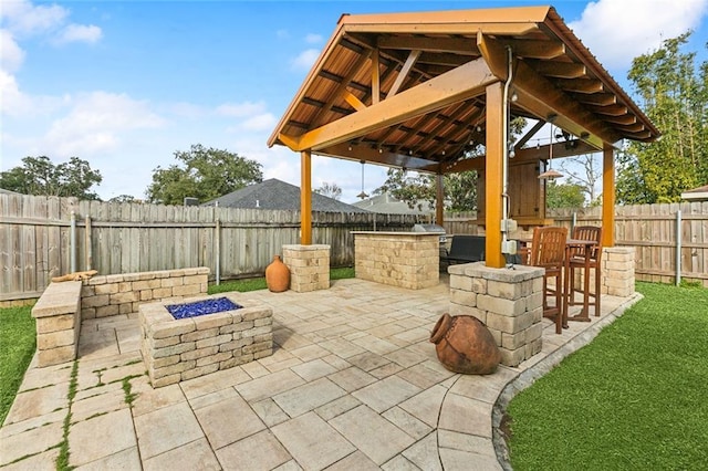 view of patio featuring a gazebo and an outdoor fire pit