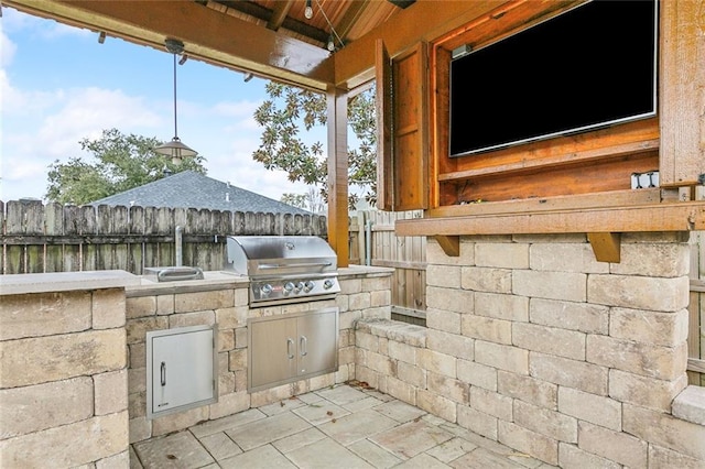 view of patio featuring area for grilling and a grill