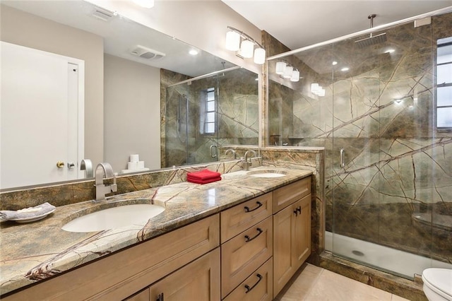 bathroom featuring vanity, toilet, and a shower with door