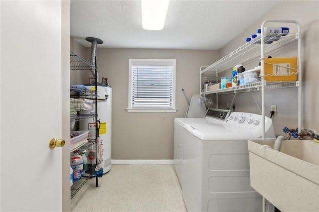 washroom with water heater, separate washer and dryer, sink, and a textured ceiling