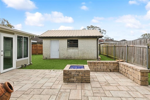 view of patio with an outdoor fire pit and an outdoor structure