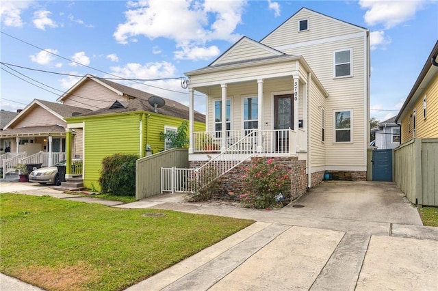 view of front of house featuring covered porch and a front lawn