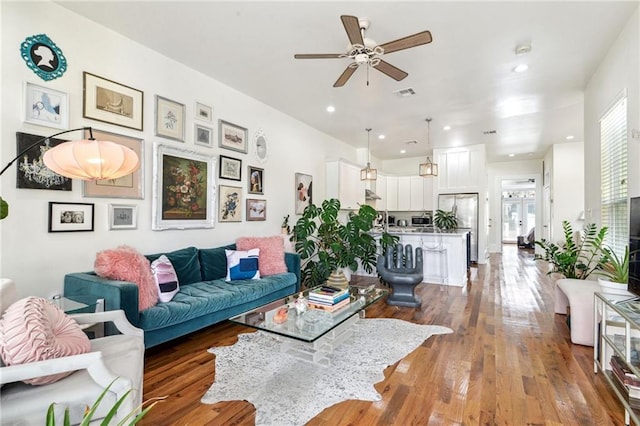 living room with ceiling fan, dark hardwood / wood-style flooring, and a healthy amount of sunlight