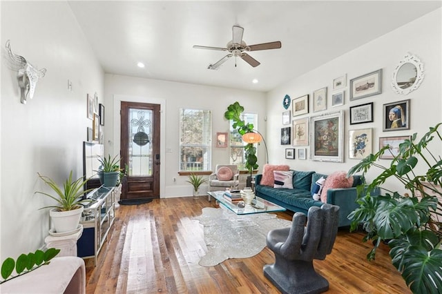 living room featuring ceiling fan and hardwood / wood-style flooring