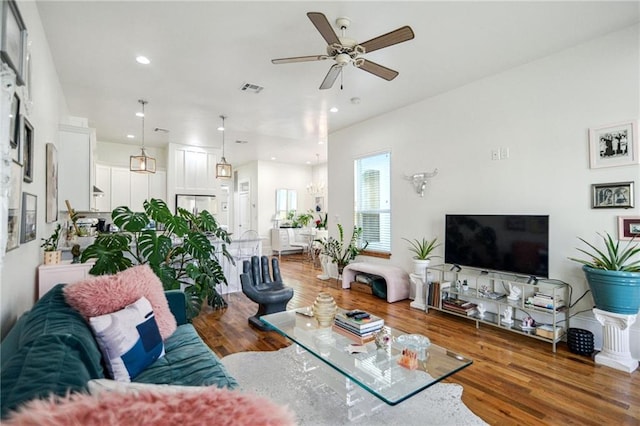 living room featuring ceiling fan and hardwood / wood-style flooring