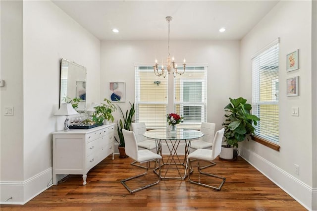 dining space with dark wood-type flooring and a chandelier