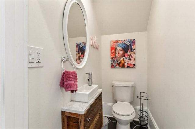 bathroom featuring toilet and vanity