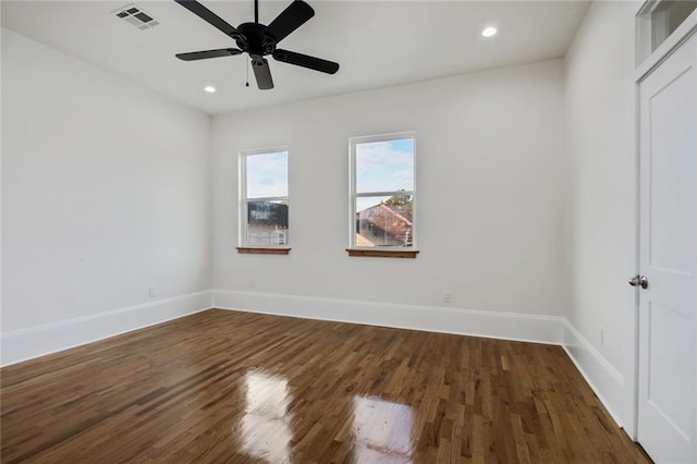 spare room featuring ceiling fan and dark hardwood / wood-style flooring