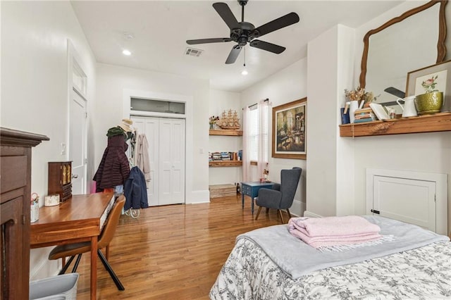 bedroom with ceiling fan, wood-type flooring, and a closet