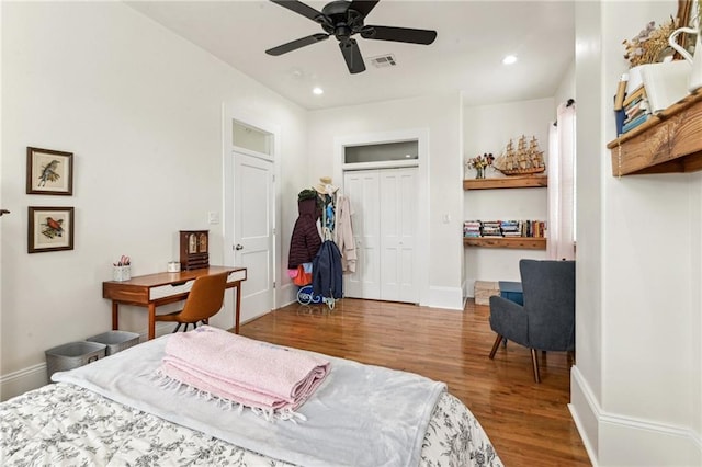 bedroom with ceiling fan, a closet, and hardwood / wood-style floors