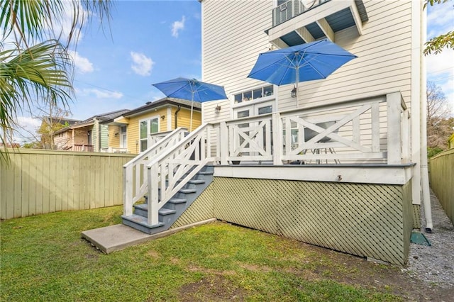 rear view of property with a lawn and a deck