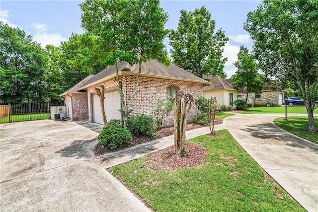 view of front of property with a garage and a front lawn